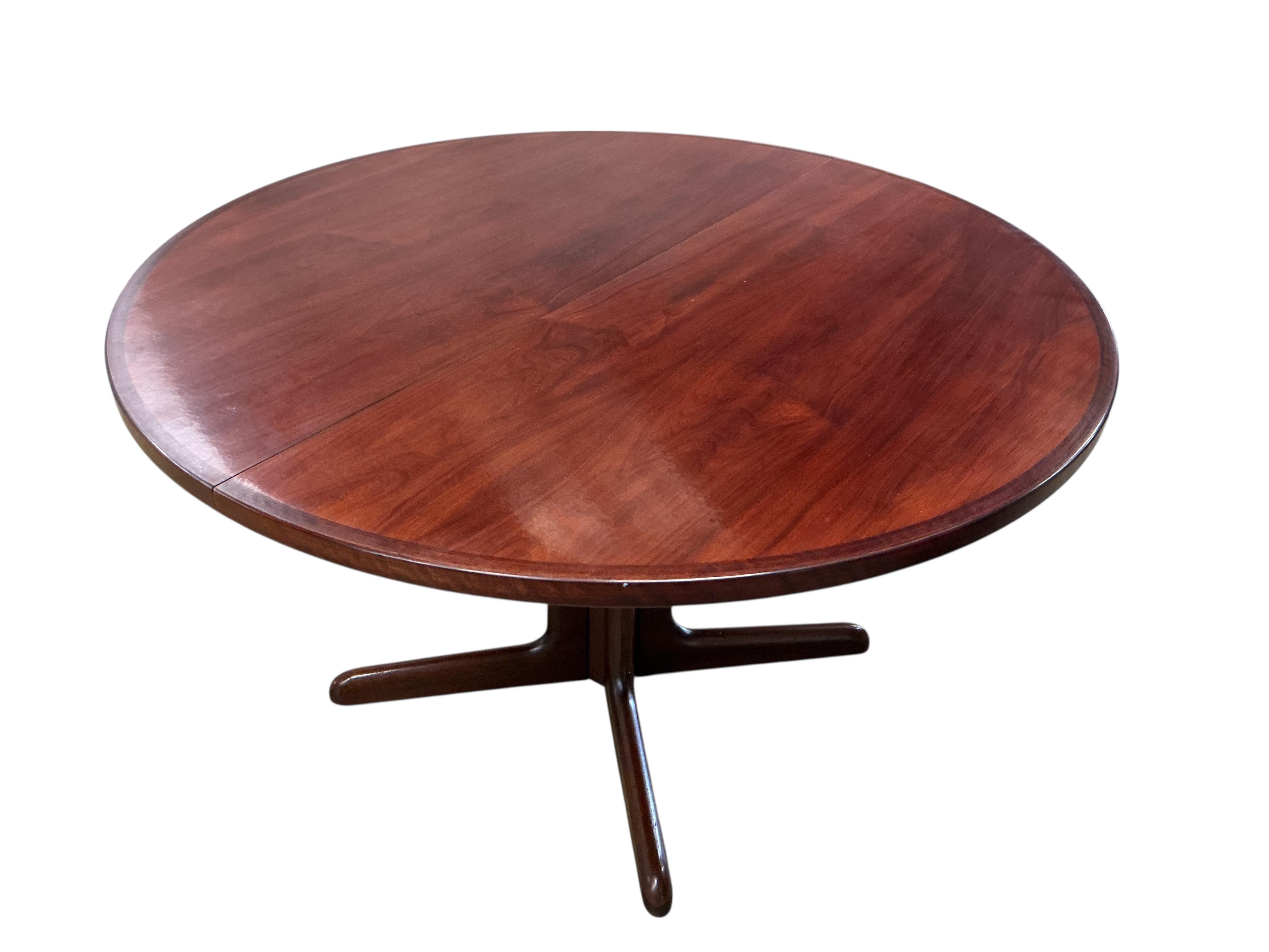 Niels Otto Møller (Danish, 1920-1982) for Gudme Mobelfabrik, a mid century Indian rosewood circular extending dining table, 218cm extended, two spare leaves, height 72cm